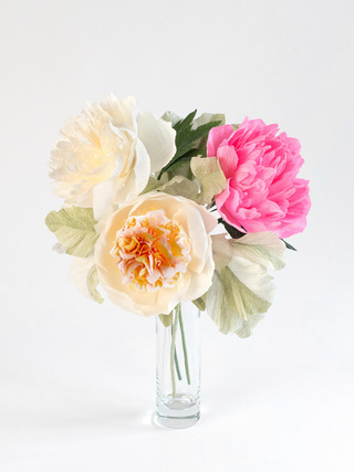 A handmade paper flower arrangement featuring 3 large, full-bloom peonies in shades of blush pink, ivory, and ivory with pink and cream interior. The delicate petals have realistic texture and gentle curves, arranged with sage green paper lamb's ear leaves.