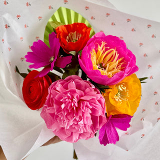 Colorful crepe paper bouquet of flowers on a white background