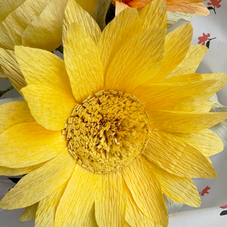 Close-up of a yellow paper sunflower with a blurred background
