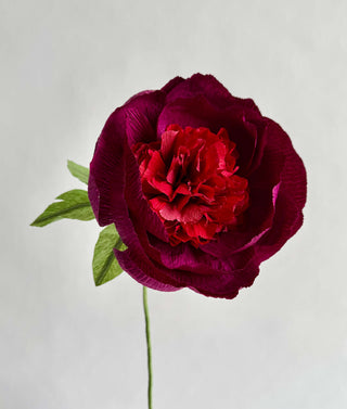 a row of burgundy petals surrounds the fluffy wine and burgundy interior of textured crepe paper to mimic the look and feel of this springtime gem